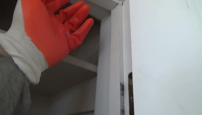 Clean old caulking and excess wood from the door stop area.