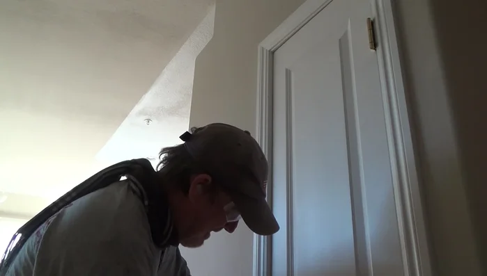 Using one nail at the top and bottom, tack the door stop into the desired position. Do not fully set the nails yet.