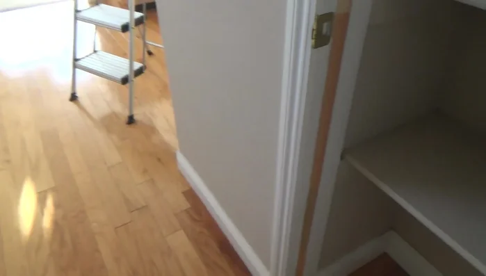 Using one nail at the top and bottom, tack the door stop into the desired position. Do not fully set the nails yet.