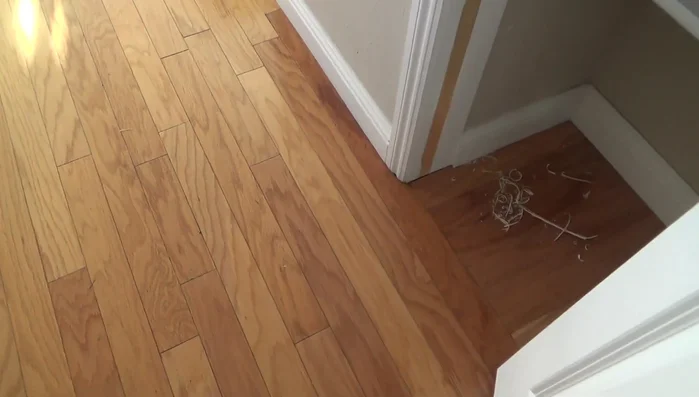 Clean old caulking and excess wood from the door stop area.