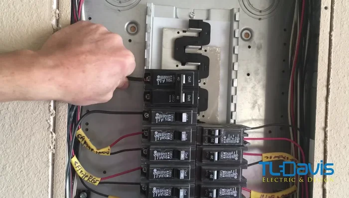 Reconnect the wires to the relocated breaker. Ensure the wires are fully inserted before tightening the screws.