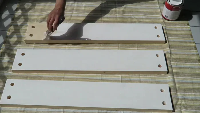 Paint the boards (optional): Paint the boards while the rope is hanging to get a sense of the shelf's placement.