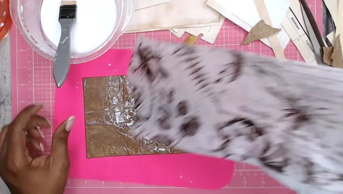 Add decorative layers: Apply decorative tissue paper over the packing paper using Mod Podge.