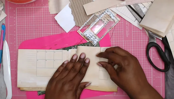 Create the journal pages: Fold and assemble paper signatures using misprinted or leftover inserts.