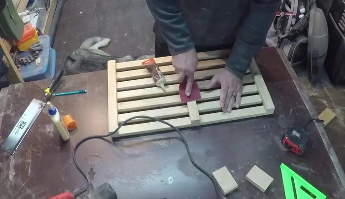 Apply two coats of spar urethane, sanding lightly between coats with 320-grit sandpaper for a smooth, water-resistant finish.