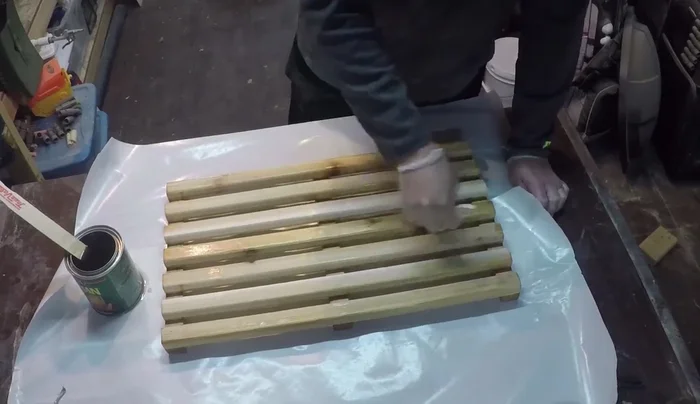 Apply two coats of spar urethane, sanding lightly between coats with 320-grit sandpaper for a smooth, water-resistant finish.