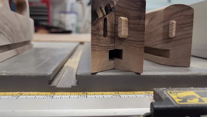 Cut dados for the bottom. The video highlights a mistake made by not locking the fence. To fix, find the highest dado, rip all to that height, and then carefully cut down to the desired height for a consistent fit.