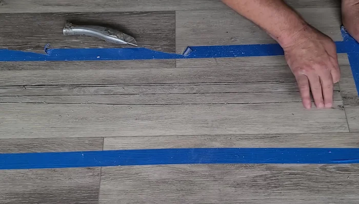 Carefully remove the damaged plank by wiggling it loose, starting on the tongue side to avoid damage.