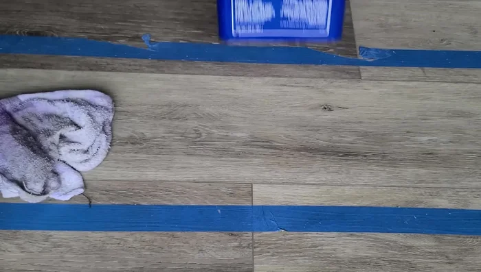 Apply weight to the new plank overnight to allow the glue to set completely.