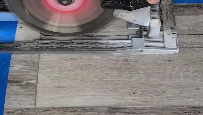 Carefully remove the damaged plank by wiggling it loose, starting on the tongue side to avoid damage.