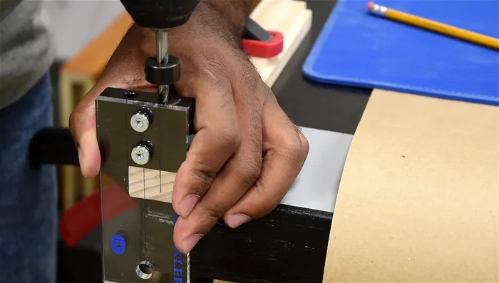 Create drawer slide tracks using a router and making sure there's a little play for smooth operation.