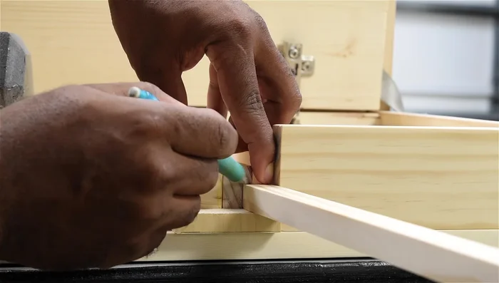 Create drawer slide tracks using a router and making sure there's a little play for smooth operation.