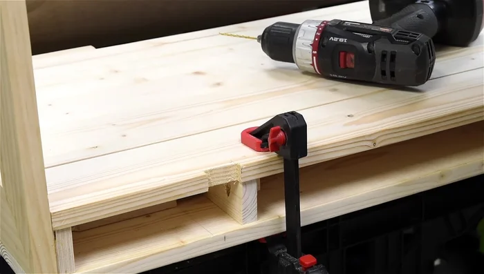 Attach the desk to the wall brackets using screws.