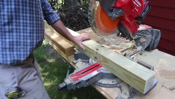 Attach 4x4 posts to frame: Attach the 4x4 posts to the frame using 3-inch deck screws, then reinforce with 1/2-inch lag bolts for extra strength. 