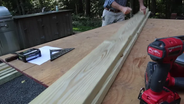 Assemble the base: Attach the cross braces to the 2x6s using 3-inch deck screws. Use clamps for easier assembly.