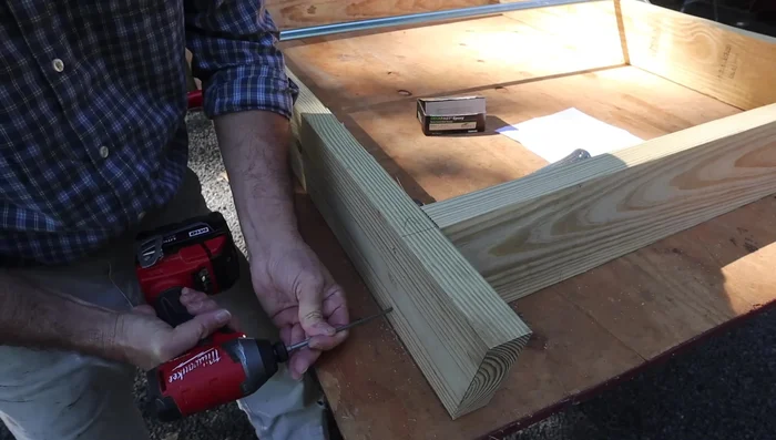 Assemble the base: Attach the cross braces to the 2x6s using 3-inch deck screws. Use clamps for easier assembly.