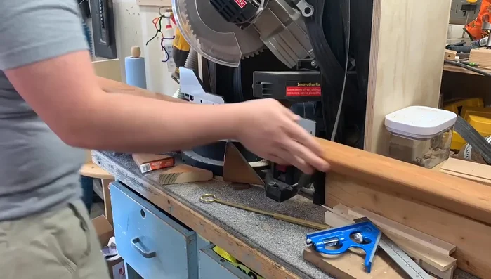 Cut and attach a top cap made of pre-treated wood using miter cuts and a nail gun for a finished look.