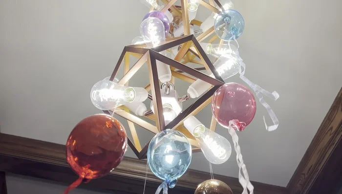 Add lighting using a lighting split with LED lights and glass bulb decorations.