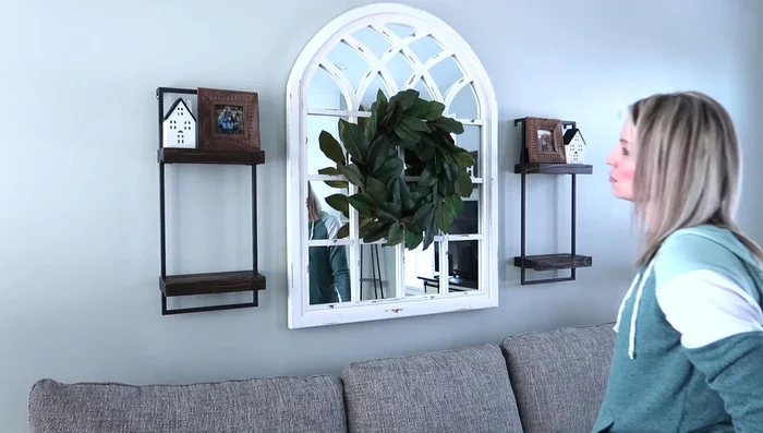 Decorating the Mantle: Add wall art, an arch-shaped decor piece, candlesticks, and a vase with greenery to the mantle.