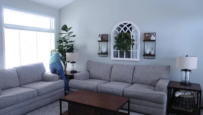 Decorating with a Blanket Ladder: Hang blankets on a ladder to balance the tall plant and conceal cable boxes.