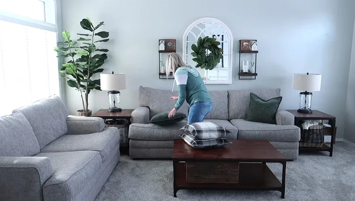 Decorating with Pillows: Arrange neutral-toned pillows on the couch and chairs.