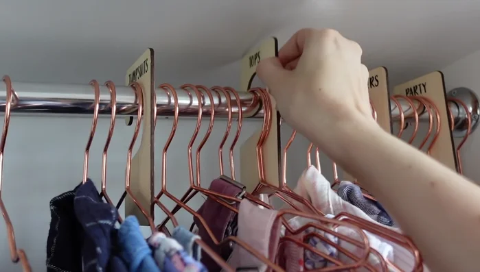 Use a "wear again" hook for clothes worn once but not needing washing to reduce laundry and morning outfit struggles. Prepare outfits the night before using this hook.