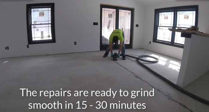 Grind off the excess repair material using a grinder with a vacuum attachment.