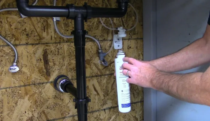 Align the filter with the bracket arrow and twist to lock it into place.