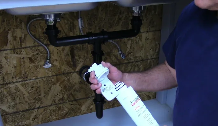 Install the faucet from the top, then tighten it from underneath the sink using a basin wrench if needed.
