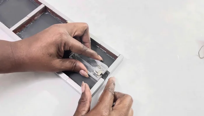 Secure the batteries using electrical tape, cutting away excess plastic to leave the bottom open for easy on/off access.