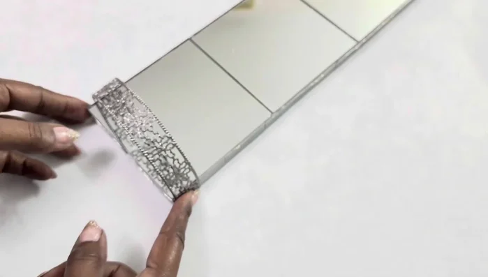Paint the metal ribbon with the same silver metallic paint used on the wood.