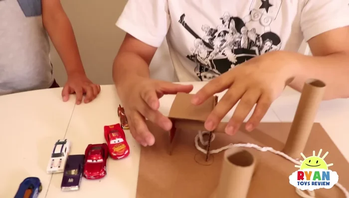 Attach the side pieces securely using hot glue to prevent them from falling. Adult supervision is recommended for using a hot glue gun.