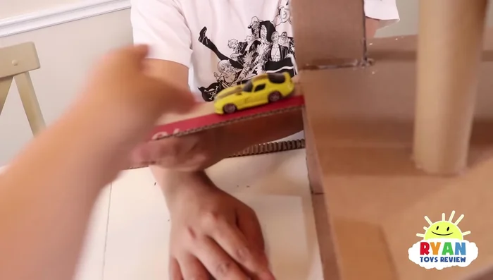 Add additional borders or barriers to the slides and upper levels to prevent cars from falling out.