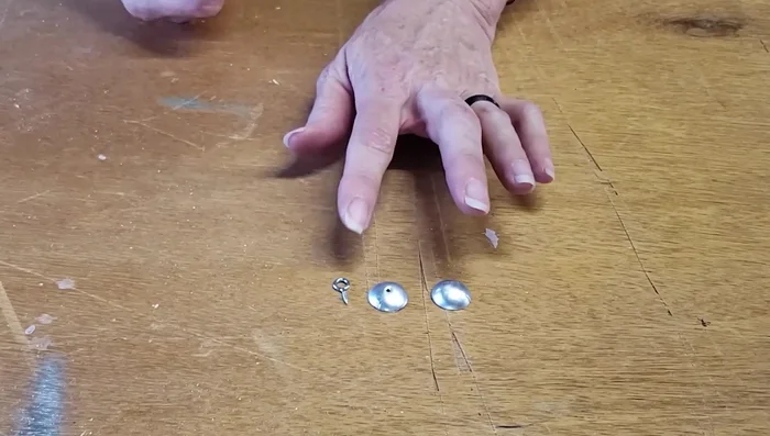 Assemble the charms by attaching an eyelet to one of the domed aluminum pieces using E6000 or hot glue.