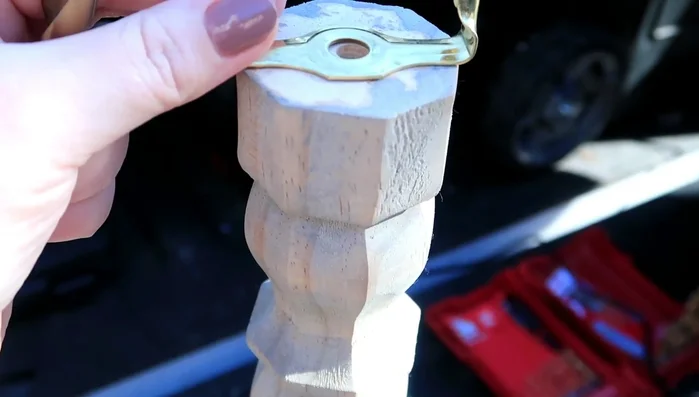 Attach the smaller base piece to the larger base piece using screws.