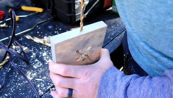 Drill a hole on the side of the base for the lamp wire and a hole all the way through for wire passage.