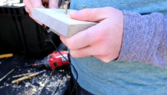 Partially unscrew two screws on the top piece, insert the lamp wire ends (bent into an upside-down U-shape) into the screws, and tighten.