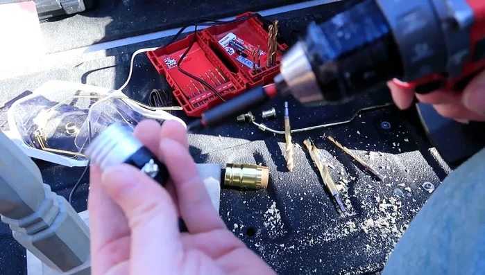 Partially unscrew two screws on the top piece, insert the lamp wire ends (bent into an upside-down U-shape) into the screws, and tighten.