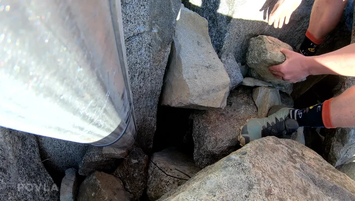 Secure the base of the flagpole firmly with rocks to prevent movement