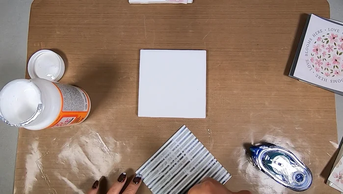 Apply Mod Podge to the back of the scrapbooking paper, extending to the edges.