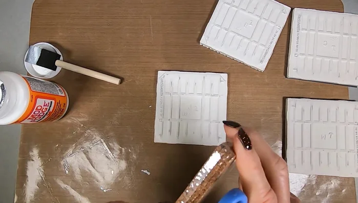 Attach cork backing: Apply Mod Podge to the back of the coaster and adhere the cork tile. Smooth out any air bubbles.