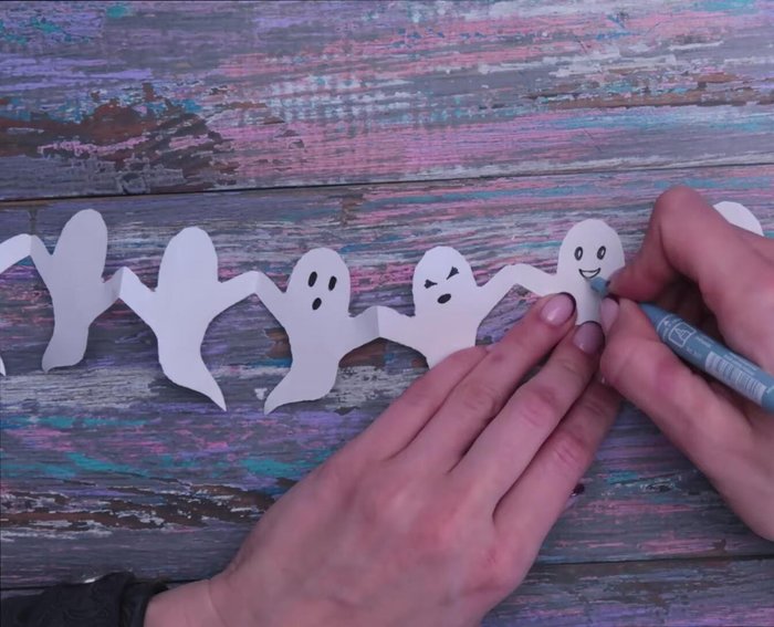 Optional: Add details like faces to your characters using a liner or stencils.