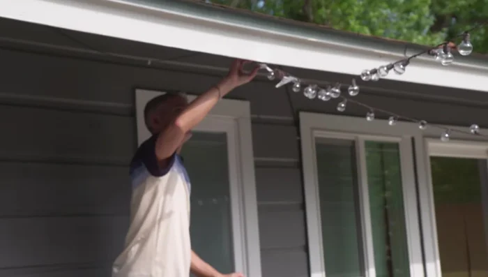 Secure the lights: Attach the lights to your planters using the hooks on the poles. If extending lights to your house, use cup hooks or other suitable methods to secure them to your roofline or siding. Use zip ties to secure the cafe lights to the hooks for added stability.