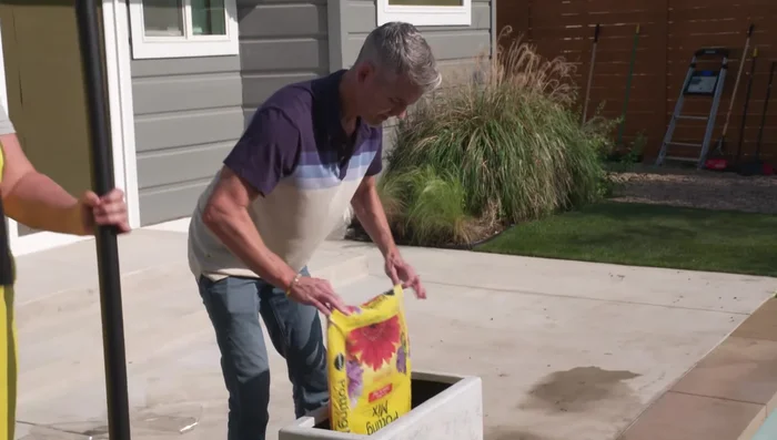 Fill the planters: Fill your planters with potting soil. For added stability in windy areas, consider adding a layer of stones to the bottom before adding soil.