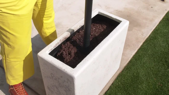 Install the poles: Place the adjustable poles into the planters, ensuring they are secure and won't topple over.