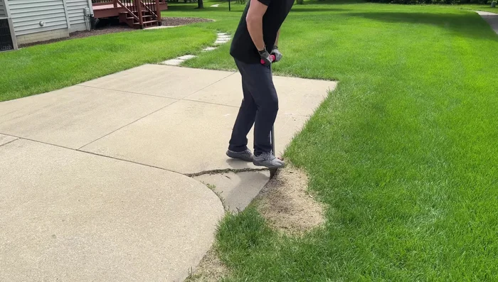 Break up the remaining chunk into smaller, manageable pieces using a sledgehammer.