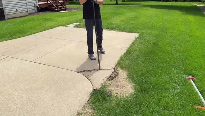 Break up the remaining chunk into smaller, manageable pieces using a sledgehammer.