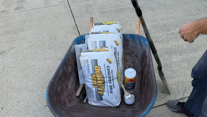 Pour and place the concrete, using a shovel and ensuring it’s level with the surrounding concrete.