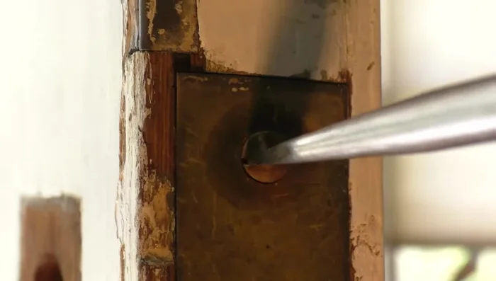 Remove the lock case by unscrewing a couple of screws. If you have a thumb trigger, lift it out of the way first.