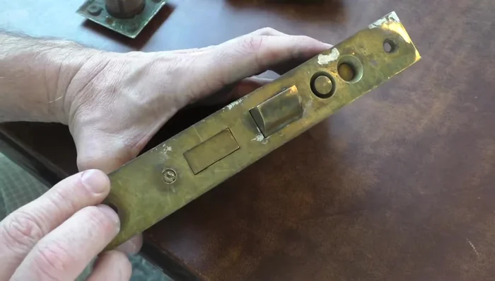 Remove the side plate to access the internal mechanisms.